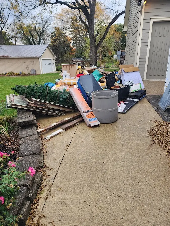 Dumpster being loaded with debris for Commercial Dumpster Rental in Laurinburg